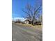 A quaint single-story home complemented by mature trees under a clear blue sky at 6944 E 300 S, Greenfield, IN 46140