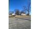 Exterior view of a home with a detached garage and expansive yard under clear blue skies at 6944 E 300 S, Greenfield, IN 46140