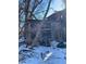 Old shed in winter, surrounded by trees and snow, evoking a rustic, secluded atmosphere at 6944 E 300 S, Greenfield, IN 46140