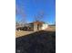 Exterior view of the property showing a shed covered in vegetation and materials strewn around it at 6944 E 300 S, Greenfield, IN 46140