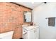 Bathroom with brick wall, sink and mirror at 735 Lexington Ave # 30, Indianapolis, IN 46203