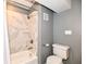 Bathroom with a tiled shower, toilet, and neutral gray walls at 735 Lexington Ave # 30, Indianapolis, IN 46203