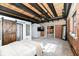 Spacious primary bedroom with brick walls, wood ceilings, beams and barn door at 735 Lexington Ave # 30, Indianapolis, IN 46203