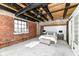 Bedroom with exposed brick walls, wood ceilings, beams and ceiling fan at 735 Lexington Ave # 30, Indianapolis, IN 46203