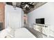 Spacious bedroom featuring a queen bed, tv, closet, and stairs to other parts of the home at 735 Lexington Ave # 30, Indianapolis, IN 46203