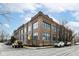 Brick apartment building featuring large windows, street parking, and manicured landscaping around the perimeter at 735 Lexington Ave # 30, Indianapolis, IN 46203