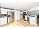 Modern kitchen with stainless steel appliances, quartz countertops, white cabinets, and wood floors at 735 Lexington Ave # 30, Indianapolis, IN 46203