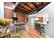 Open living space featuring modern furnishings, an open floor plan, exposed brick, and wood floors at 735 Lexington Ave # 30, Indianapolis, IN 46203