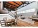Open living space featuring an open floor plan, exposed brick, modern staircase, and wood floors at 735 Lexington Ave # 30, Indianapolis, IN 46203