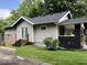 Rear view of a cozy home featuring a small porch, well-maintained siding, and lush greenery at 744 Wallace Ave, Indianapolis, IN 46201