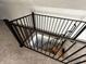 Modern stairwell with dark railing and carpeted steps at 744 Wallace Ave, Indianapolis, IN 46201