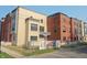 Street-level view of new condominiums showcasing mixed brick and siding with signage indicating available townhomes at 76 E Wayne St # B, Franklin, IN 46131