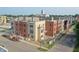 A new condominium complex featuring mixed brick and siding, surrounded by green landscaping and a historic building at 76 E Wayne St # B, Franklin, IN 46131