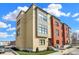 A modern condominium showcases a brick and tan facade, complemented by well-manicured landscaping and clear blue skies at 76 E Wayne St # B, Franklin, IN 46131
