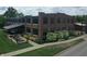 Exterior view of a brick building with large windows and a covered outdoor patio, accented by lush landscaping and green lawn at 76 E Wayne St # B, Franklin, IN 46131
