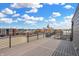Spacious rooftop deck boasts sleek railing and expansive views of the cityscape under a bright, cloudy sky at 76 E Wayne St # B, Franklin, IN 46131