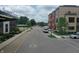 Street view of the Garment Factory neighborhood with brick buildings, green spaces, and street parking, all under a partly cloudy sky at 76 E Wayne St # B, Franklin, IN 46131