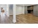 Finished basement with wood floors and view into the bar area and stairs to the upper floor at 8015 Sargent Rdg, Indianapolis, IN 46256