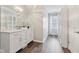 Bathroom featuring stylish vanity with ample counter space and modern fixtures plus walk-in closet at 8015 Sargent Rdg, Indianapolis, IN 46256