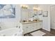 Bathroom features double vanities, granite countertops, a soaking tub, and a large mirror at 8015 Sargent Rdg, Indianapolis, IN 46256