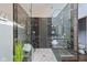 Modern bathroom with tile-walled glass shower and seating area with dual shower heads at 8015 Sargent Rdg, Indianapolis, IN 46256