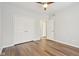 Bedroom with wood-look flooring, a ceiling fan, and a closet with white doors at 8015 Sargent Rdg, Indianapolis, IN 46256