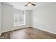 Bedroom boasts wood-look floors, a ceiling fan, and a window nook with built-in cabinets at 8015 Sargent Rdg, Indianapolis, IN 46256