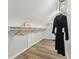 Walk-in closet with wood floors and built-in shelving and a hanging black robe at 8015 Sargent Rdg, Indianapolis, IN 46256