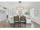 Well-lit dining room with contemporary decor, a modern light fixture, and hardwood floors at 8015 Sargent Rdg, Indianapolis, IN 46256
