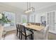 Elegant dining room with a modern light fixture and views of the outdoor scenery at 8015 Sargent Rdg, Indianapolis, IN 46256