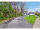 Long driveway leading to a light-blue home with a three-car garage and mature landscaping at 8015 Sargent Rdg, Indianapolis, IN 46256
