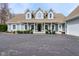 Charming light-blue home with a welcoming front porch and well-maintained landscaping at 8015 Sargent Rdg, Indianapolis, IN 46256
