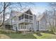 View of the back exterior featuring a screened porch and multiple levels with a well manicured lawn at 8015 Sargent Rdg, Indianapolis, IN 46256
