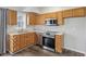 Cozy kitchen with stainless steel appliances, wooden cabinets, and double basin sink at 8015 Sargent Rdg, Indianapolis, IN 46256