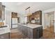 Kitchen with large island, granite countertops, stainless appliances, and dark wood cabinets at 8015 Sargent Rdg, Indianapolis, IN 46256