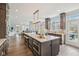 Kitchen with large granite island, stainless appliances, wood floors, and open floor plan at 8015 Sargent Rdg, Indianapolis, IN 46256