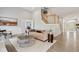 Bright living room with hardwood floors, neutral decor, and staircase access at 8015 Sargent Rdg, Indianapolis, IN 46256