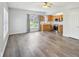 Living room with hardwood floors, neutral paint, and view of kitchen area at 8015 Sargent Rdg, Indianapolis, IN 46256