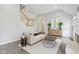 Spacious living room with hardwood floors, fireplace, and staircase with a modern design at 8015 Sargent Rdg, Indianapolis, IN 46256