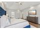 Bright main bedroom features a tray ceiling, decorative furniture, and an ensuite bathroom at 8015 Sargent Rdg, Indianapolis, IN 46256