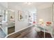 Stylish home office featuring a white desk, window seat, modern shelves, and large mirror at 8015 Sargent Rdg, Indianapolis, IN 46256