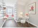 Bright office space with a white desk, plush stool, and built-in shelving and window seat at 8015 Sargent Rdg, Indianapolis, IN 46256