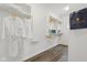 Spacious walk-in closet with built-in shelving, wooden hangers, and wood-look flooring at 8015 Sargent Rdg, Indianapolis, IN 46256