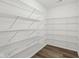 Walk-in closet with white wire shelving and hardwood floors at 8015 Sargent Rdg, Indianapolis, IN 46256
