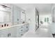 Modern bathroom boasts double sink vanity, marble floors, walk-in shower and bright lighting at 8061 Lower Bay Ln # 1, Indianapolis, IN 46236