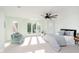 Spacious bedroom with natural light, a ceiling fan, and cozy sitting area at 8061 Lower Bay Ln # 1, Indianapolis, IN 46236