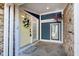 Charming front porch with a pop of color from the yellow door and hanging flower basket at 8061 Lower Bay Ln # 1, Indianapolis, IN 46236