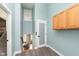Hallway leads to living room, featuring wood-look flooring and cabinets at 8061 Lower Bay Ln # 1, Indianapolis, IN 46236