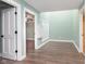 Hallway with durable floors, neutral color, and white trim, offers seamless transition at 8061 Lower Bay Ln # 1, Indianapolis, IN 46236