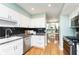 Modern kitchen with stainless steel appliances, white cabinetry, and stylish backsplash at 8061 Lower Bay Ln # 1, Indianapolis, IN 46236